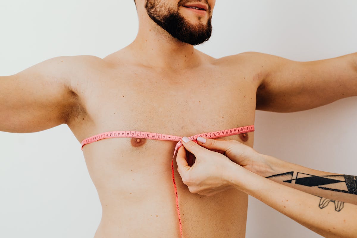 Demonstrating proper chest measurement technique with flexible tape measure