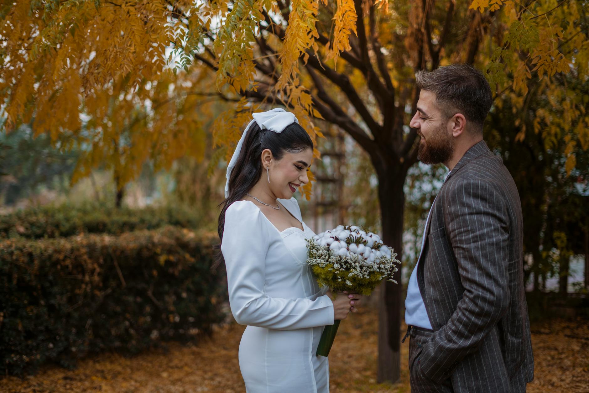 Groom in a navy wedding suit photographed in autumn outdoor light