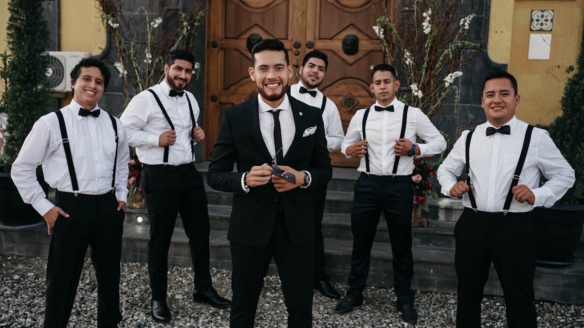 Groomsmen posing together in coordinated suits before a wedding ceremony