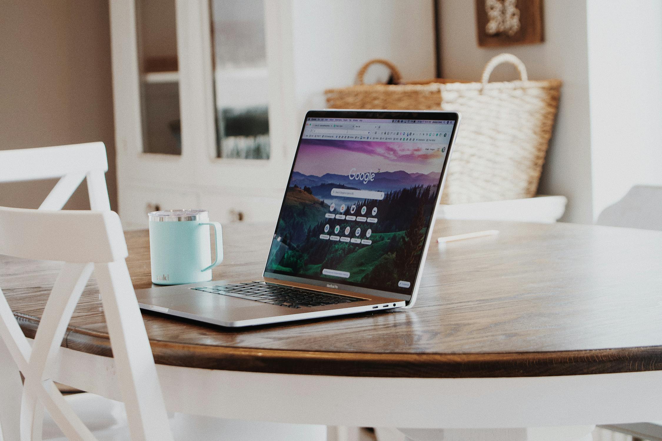 Couple browsing wedding planning websites on a laptop in a bright modern living room